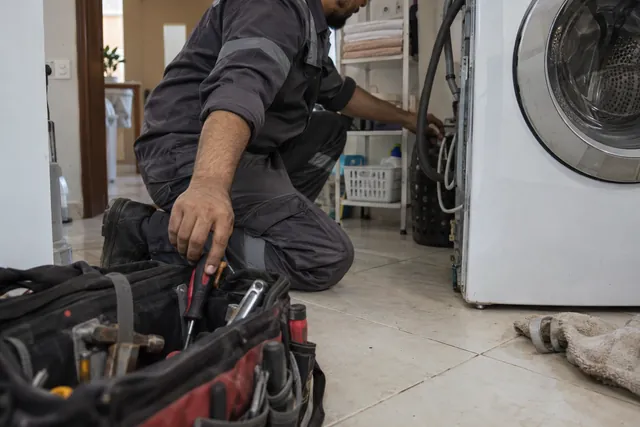 Technician testing a washing machine inlet valve